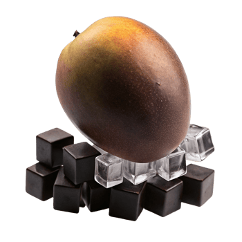 A single ripe mango rests on a bed of ice cubes and dark chocolate squares png
