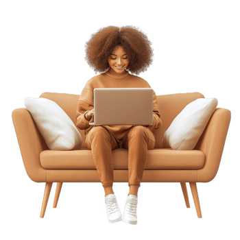 Woman with curly hair sitting on a cozy couch using a laptop looks focused and comfortable png