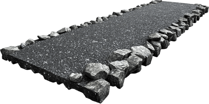 A paved pathway is bordered with natural gray stones. The paths dark surface contrasts with the stone borders creating visual interest. png