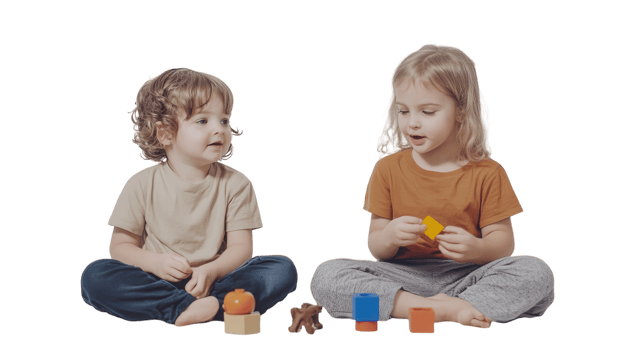 Young children explore colorful building blocks and toys while engaged in playtime activity indoors png