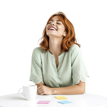 A woman is laughing while sitting at a table with a cup of coffee png