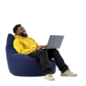 A man sitting on a bean bag chair with a laptop png