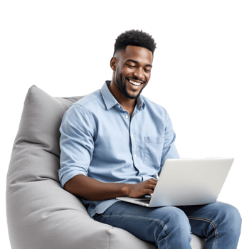 A smiling man sitting on a bean bag chair with a laptop png