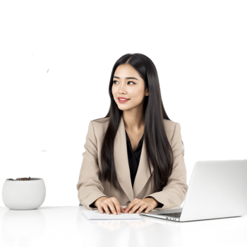 Asian businesswoman sitting at desk with laptop and plant png