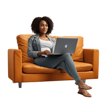Focused woman sitting on a brown couch working on a laptop png