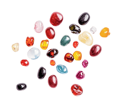 Colorful assorted gemstones arranged on black surface png