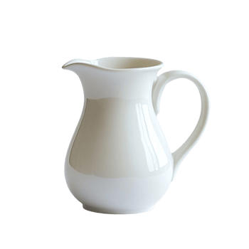 A classic ceramic milk jug standing elegantly. png
