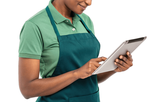 person in green shirt and apron using tablet, showcasing intersection of food and technology in professional setting png