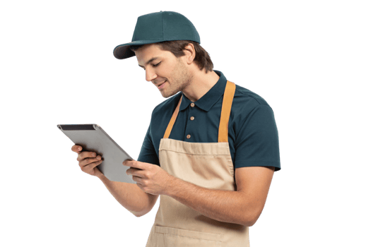 Young man in apron using tablet, engaged in food technology, smiling with enthusiasm while checking orders png