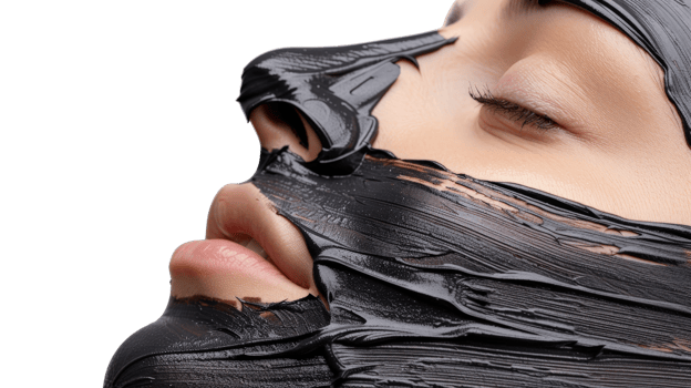 Close-up of Woman with Black Face Mask Applying Skincare Treatment for Beauty and Relaxation at Home or Spa Environment png