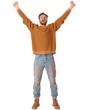 Happy young man celebrating success with arms raised, wearing a cozy sweater and jeans, standing confidently on white background png