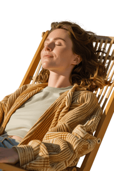 Woman Relaxing in Sunlight on a Deck Chair, Enjoying Peaceful Moment with Eyes Closed and Comforting Atmosphere png