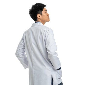 young male scientist in lab coat stands confidently, showcasing professional demeanor in biotechnology setting png