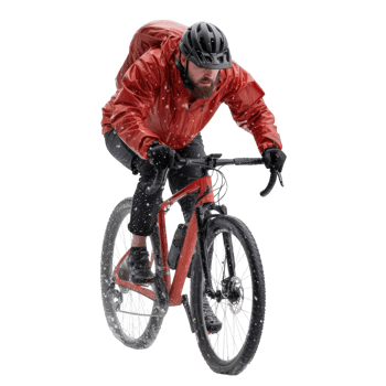 Cyclist Riding Mountain Bike Through Snowy Trail in Winter Weather Conditions png