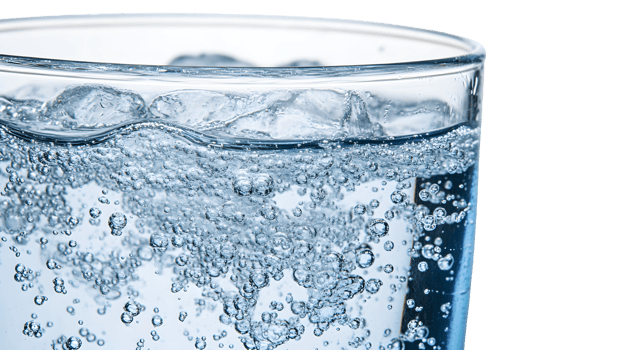 Closeup of Sparkling Water in Glass with Bubbles and Ice png
