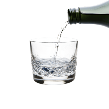 Refreshing Clear Liquid Being Poured into a Crystal Glass Container png