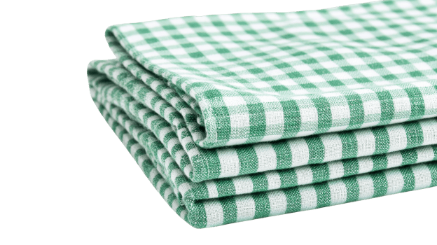 Stack of green checkered napkins on black background, cut out transparent png