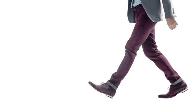 A man in a suit walking confidently showcasing professional attire and formal shoes for busine png