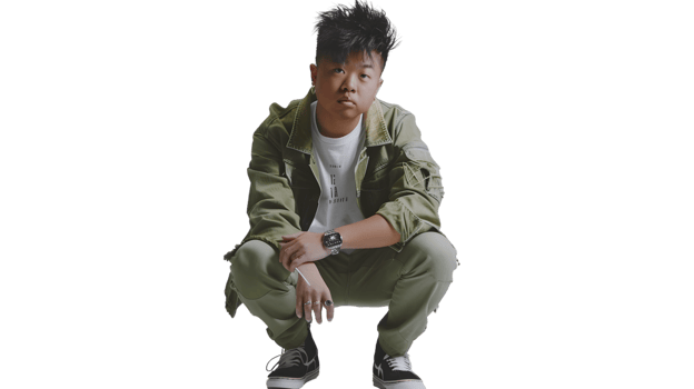 A person in a crouched position wearing a stylish outfit with a watch perfect for fashion and png