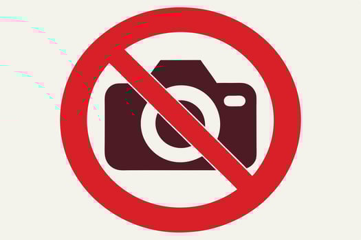 No Photography Sign, Dark Brown Camera with Red Circle and Line on White Background vector
