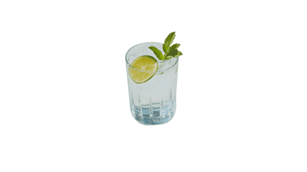 Refreshing Citrus Beverage in a Crystal Glass with Mint and Lime Garnish png