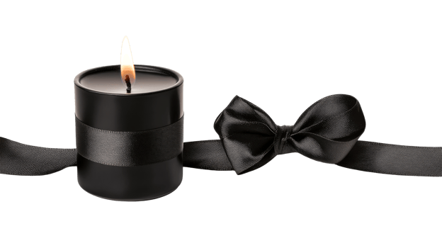 Black candle with ribbon, flame glowing bright , cut out transparent png