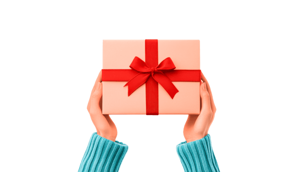 Hands holding gift with red bow in a sweater, cut out transparent png