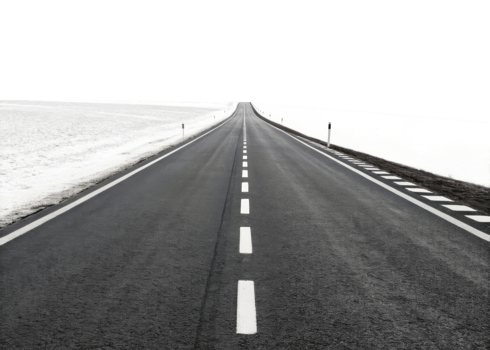 long, empty road stretches into distance, surrounded by snow covered fields, evoking sense of solitude and adventure png