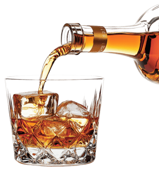 Amber Liquid Pouring into Crystal Rocks Glass with Ice Cubes Close Up png