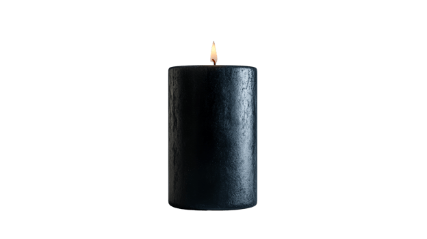 Isolated black paraffin candle with flame on dark background, cut out transparent png