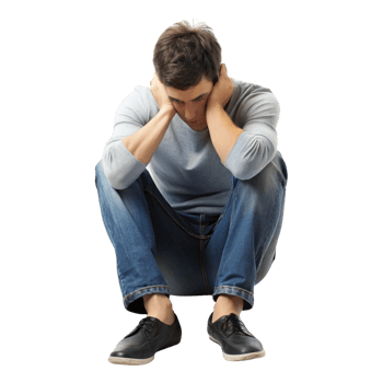 Sad young man sitting on the floor with his head resting on his hands, showing deep sorrow and emotional distress png