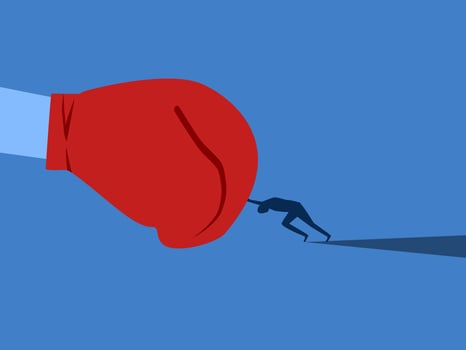 Businessman fights with giant boxing gloves vector