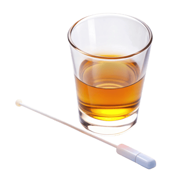 Close up of alcohol swab stick next to a glass with amber colored liquid for hygiene and antiseptic purposes png