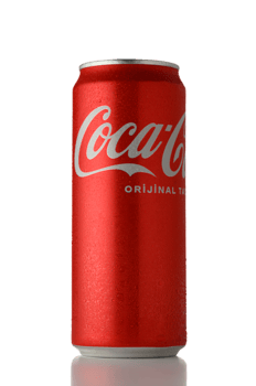 Gaziveren Cyprus -04.03.2025 Iconic red can of classic soft drink resting on a reflective surface under bright lighting png