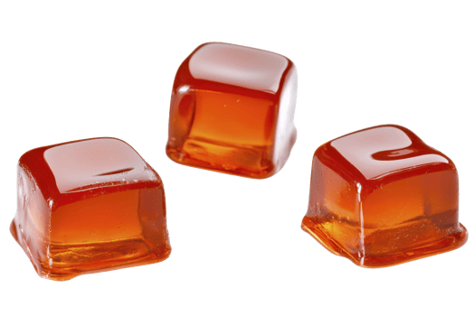 A Three translucent amber colored gelatin cubes are arranged on transparency background, showcasing their smooth texture and glossy surface. cubes appear appetizing and inviting png