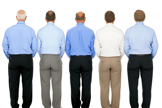 A Five men stand in row, viewed from behind, wearing formal shirts in shades of blue and white, and dress pants. image conveys sense of uniformity and professionalism png