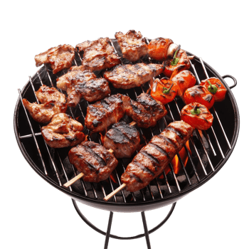 Grilled meats and vegetables on a portable barbecue. png