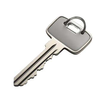 Metallic key rests on a dark, shadowed surface. png
