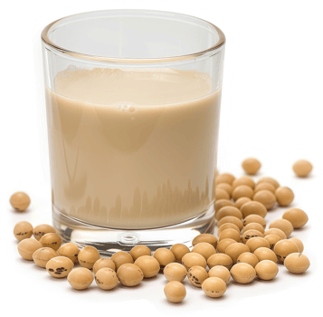 A glass of light beige soy milk surrounded by soy beans. png