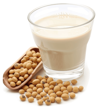 Soy milk in a glass with soybeans beside it. png