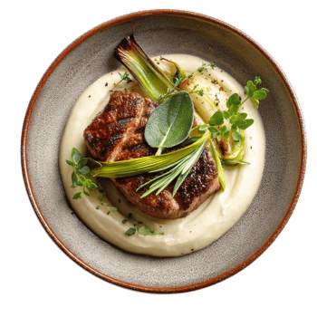 Seared Pork Chop with Creamy Mashed Potatoes and Fresh Herbs on a Rustic Plate png