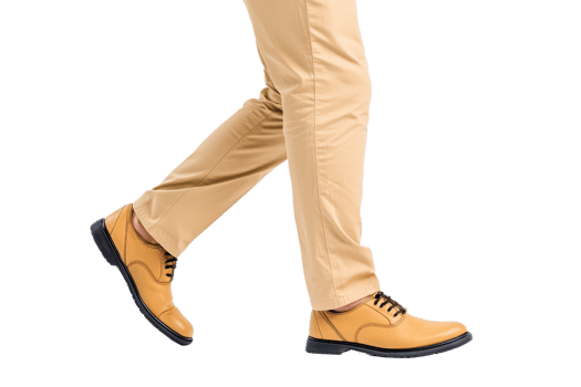 A person wearing beige pants and stylish tan leather shoes is walking forward, showcasing casual yet elegant style. shoes have black laces and sleek design, perfect for smart casual look png