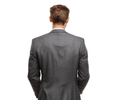 Man in a grey suit stands confidently indoors png