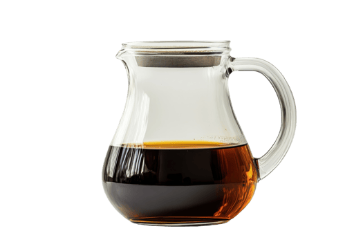 A glass pitcher filled with dark liquid, showcasing its elegant shape and handle. png