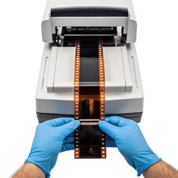 Technician inserting 35mm film into scanner on transparent background png