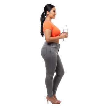 Confident Young Woman in Jeans Holding a Refreshing Bottle of Water png