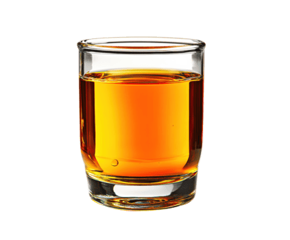 Sip of amber liquid in a clear glass on a neutral surface png