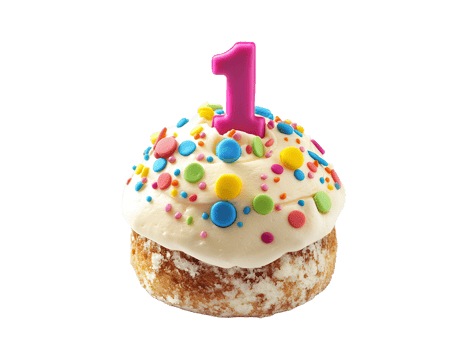 Mini cupcake with white frosting, sprinkles and number one candle png