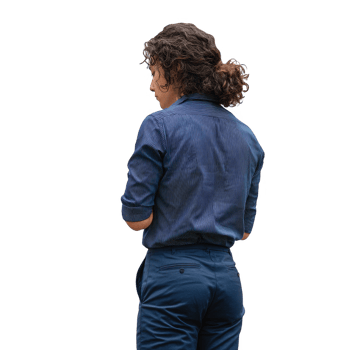 A young adult with curly hair wearing a casual outfit, standing with their back to the viewer, isolated on a white background. png
