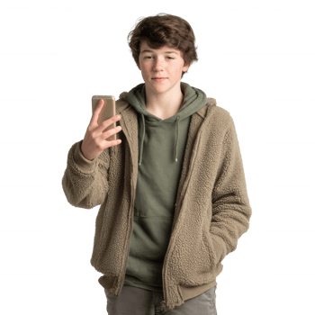 A young person casually dressed in a warm jacket, holding a smartphone while engaged in conversation, showcasing a modern lifestyle with a relaxed vibe. png